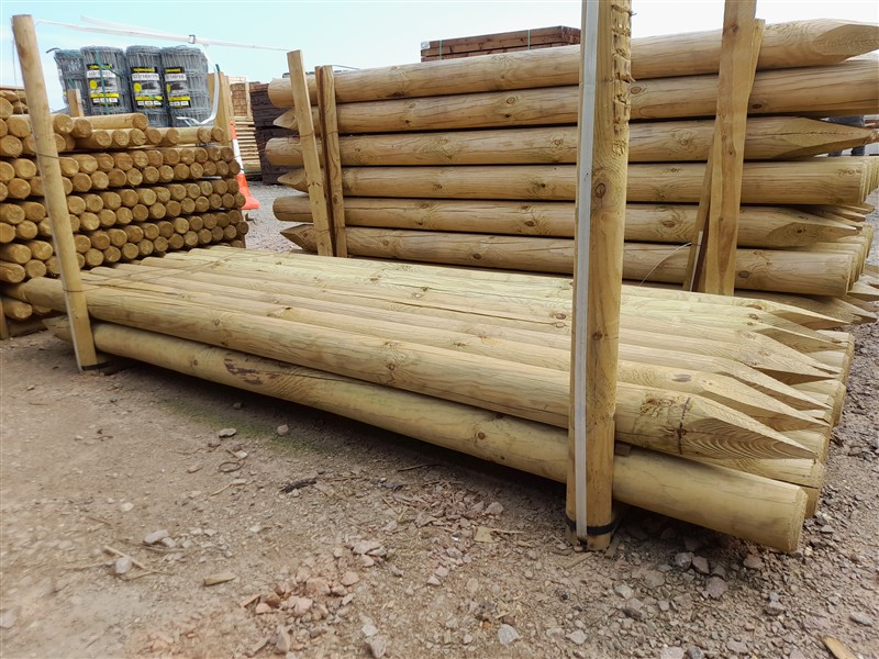 Stacked wooden fence posts in timber yard