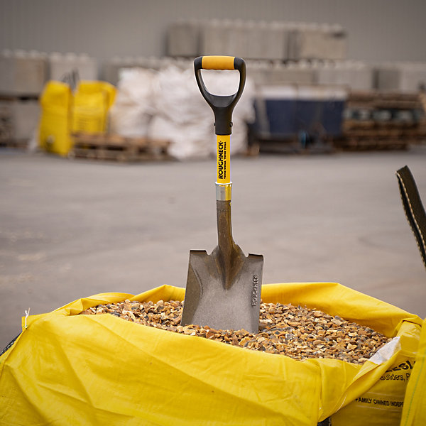 Spade standing in a bag of gravel
