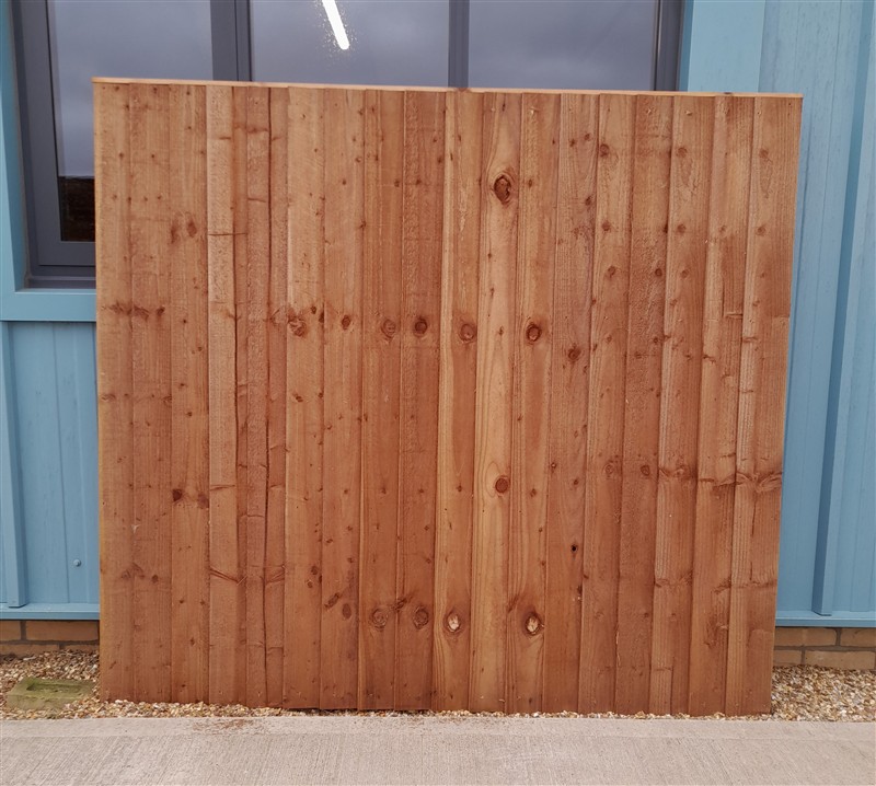Large vertical timber fence panel against blue building