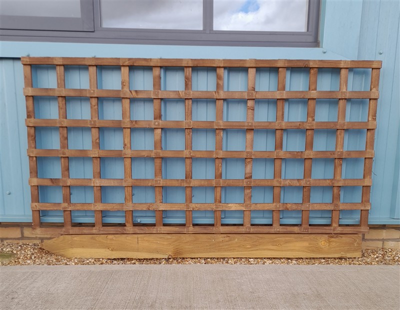 Wooden trellis mounted against pale blue exterior wall