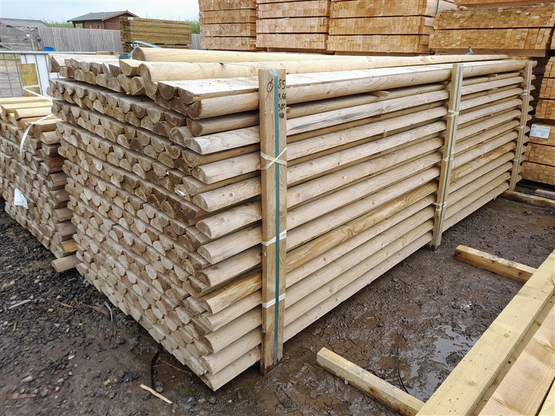 Stacked wooden fence rails in a timber yard